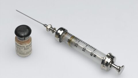 Vintage hypodermic syringe and vaccine vial