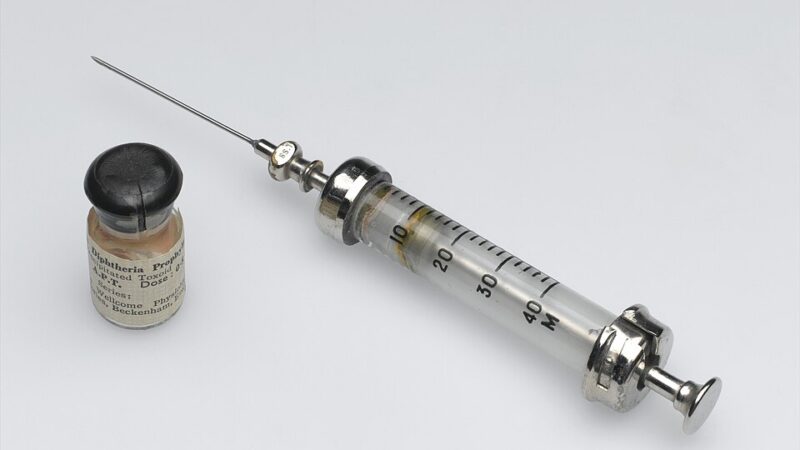 Vintage hypodermic syringe and vaccine vial