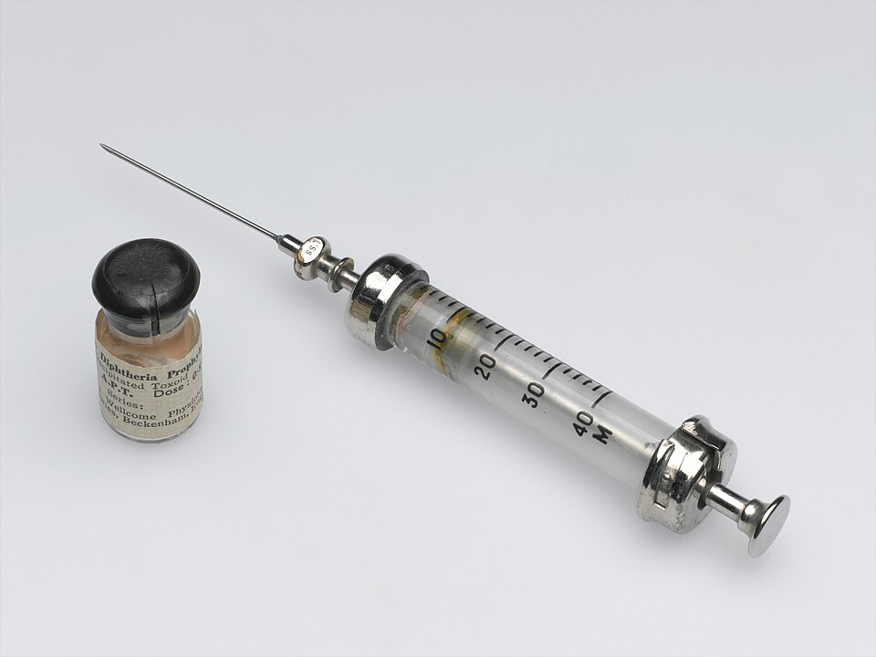 Vintage hypodermic syringe and vaccine vial