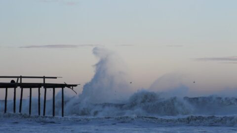 Storm waves crashing against Ocean City Maryland fishing pier