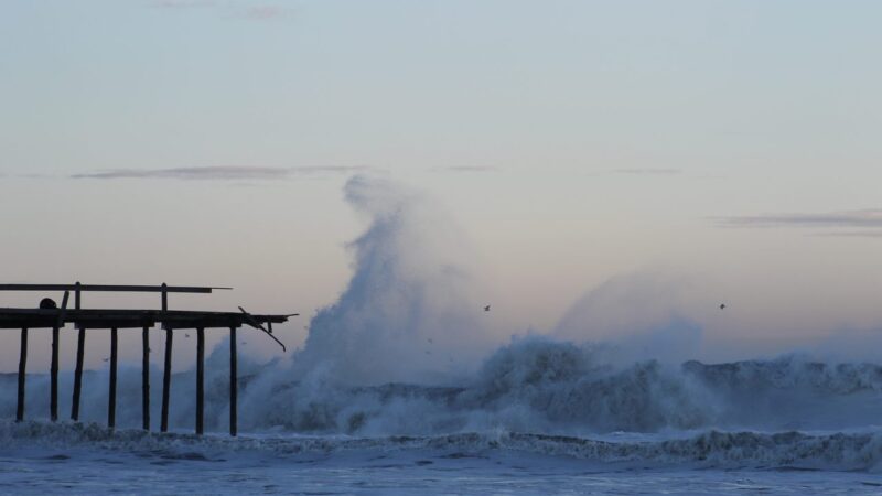 Storm waves crashing against Ocean City Maryland fishing pier