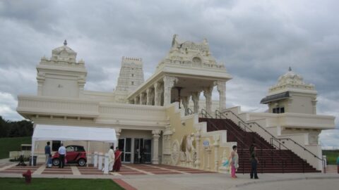 White Hindu temple building in Aurora Illinois with gopuram towers