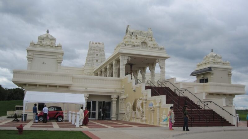 White Hindu temple building in Aurora Illinois with gopuram towers