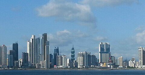 Panama City skyline across the bay under blue sky