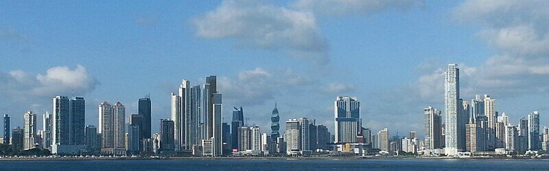Panama City skyline across the bay under blue sky